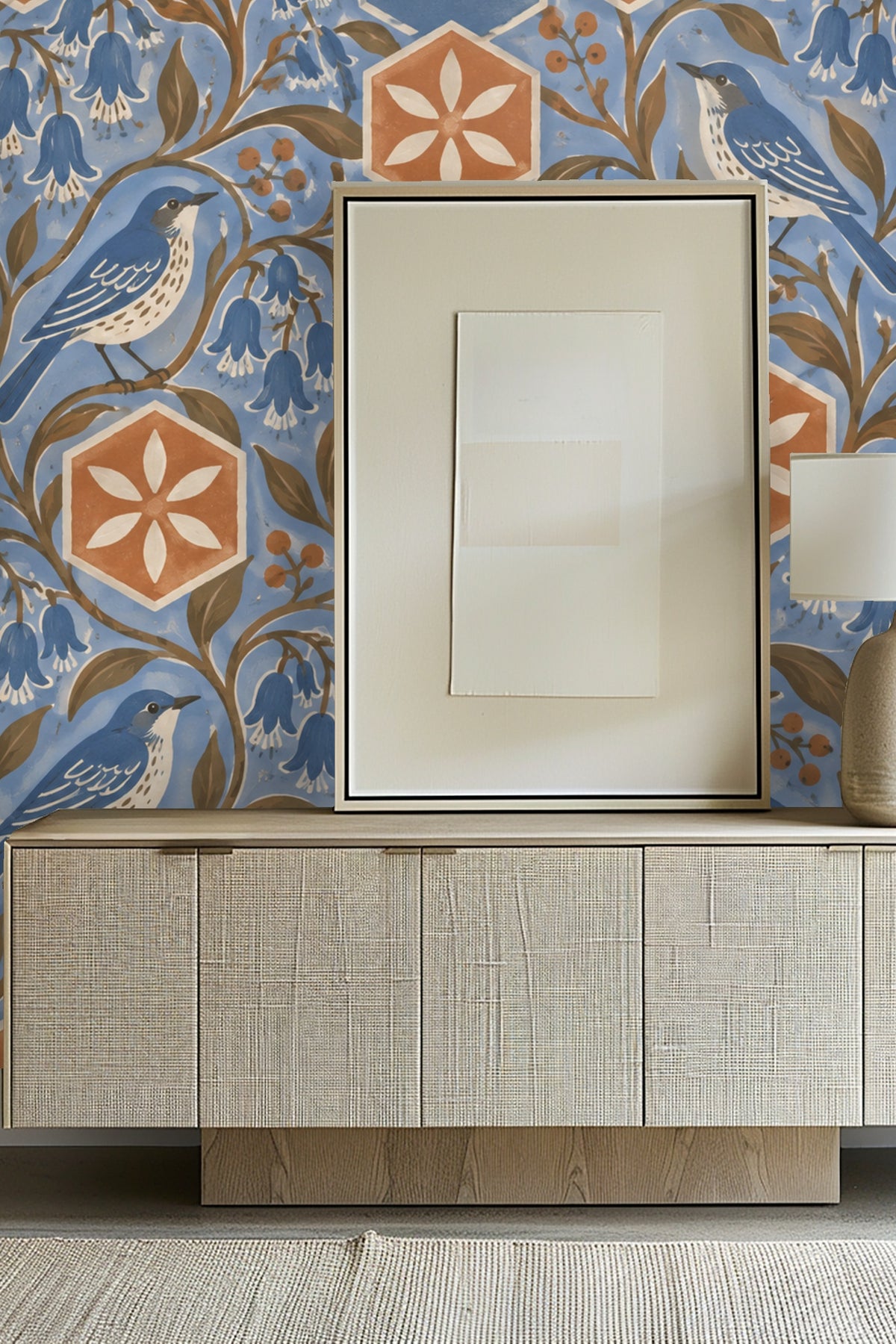 Close-up of handpainted wallpaper featuring hexagonal terracotta tiles, bluebell flowers, and bluebirds on a soft blue background