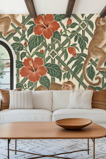 Bedroom featuring mazeleaf macaques wallpaper behind green bedframe and white bedding with colorful cushions