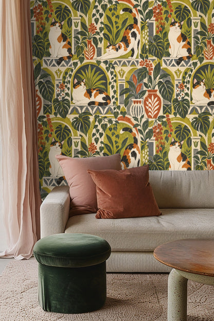Living room with curved white sofa and red armchair showing wallpaper with relaxed calico cat stretching in green and terracotta arches