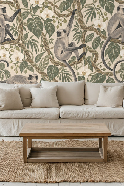 Section of wallpaper showing langur sitting with curled tail wrapped around vine, amidst large leaves and white flowers.