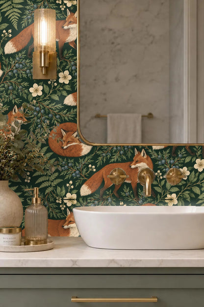 Blue velvet couch set against the Juniper Fox wallpaper with fox and juniper berry motifs