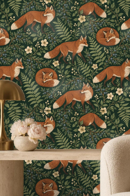 Green leafy branches intertwined with clusters of juniper berries on wallpaper