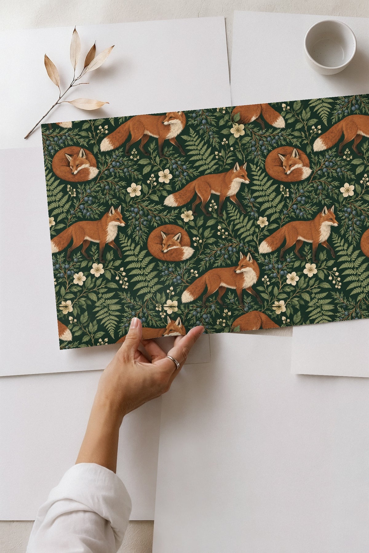 Artwork showing a mix of fern, berry, and fox elements in natural colors