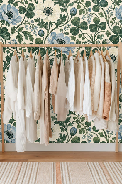 Swirling stems with four-leaf clovers and buds on wallpaper.