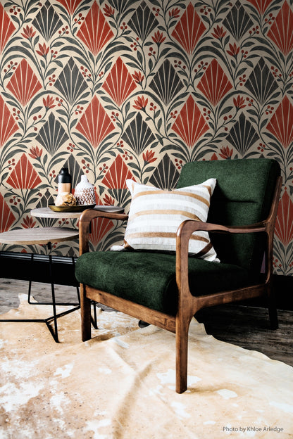 Red flower buds peek between geometric fans in wallpaper pattern