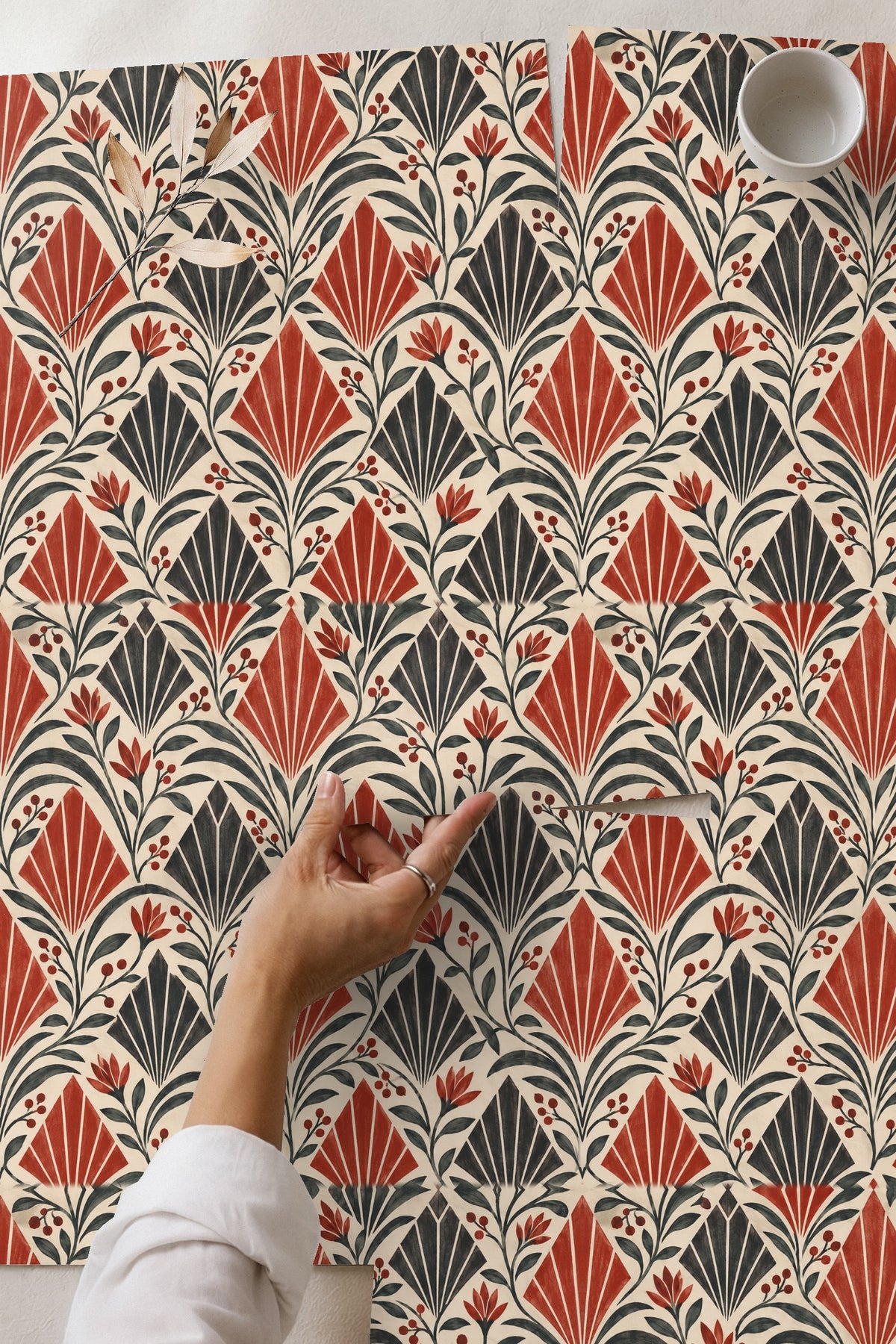 Bedroom bedside wall decorated with Crimson Apex Rhythm wallpaper, natural wicker furniture visible