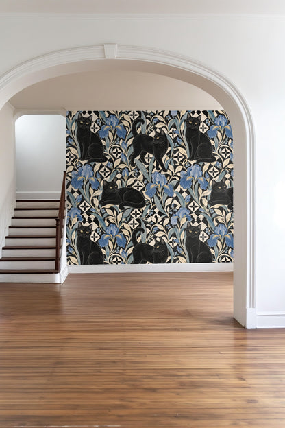 Close-up of a black cat in the wallpaper amidst blue iris and tile patterns