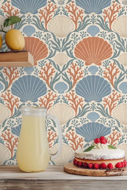 Wide shot of Coral Cove Crest wallpaper in living room highlighting scale of pattern and neutral furnishings.