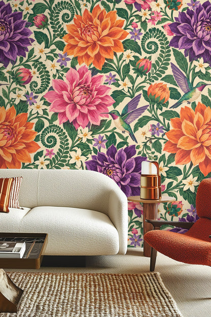 Illustration of large dahlias in purple, pink, and orange with green fern fronds and hummingbirds on cream background