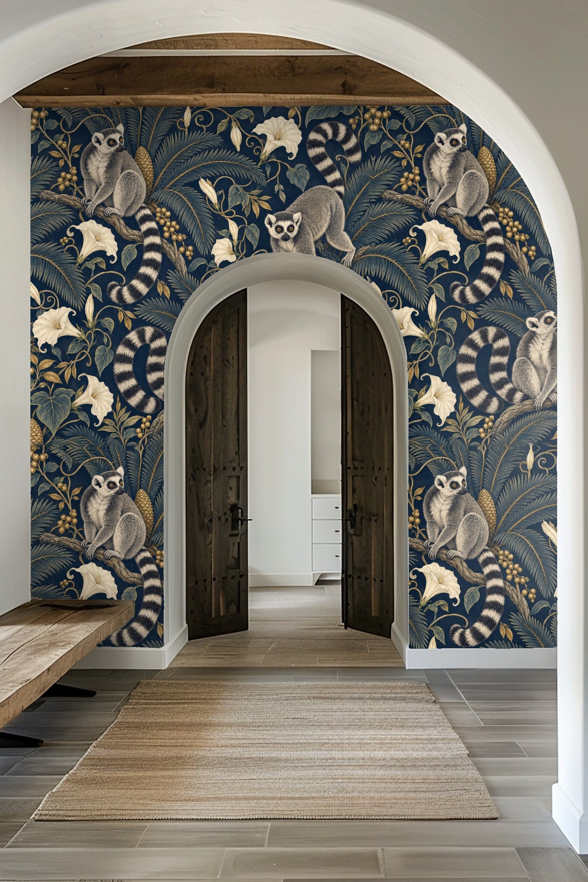 Laundry room featuring the wallpaper with ring-tailed lemurs and tropical plants behind a wooden countertop and white washers.