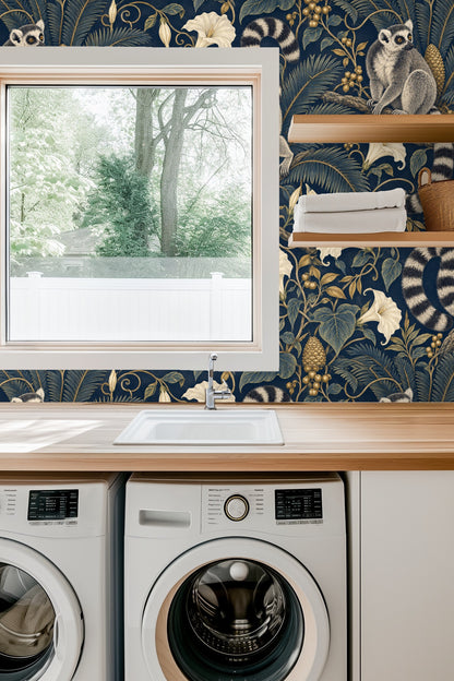 Close-up view of wallpaper with a blue velvet sofa highlighting the midnight blue background and lemur design.