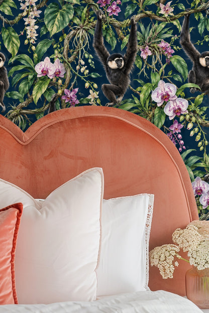 Wide view of wallpaper pattern repeating with gibbons and orchids