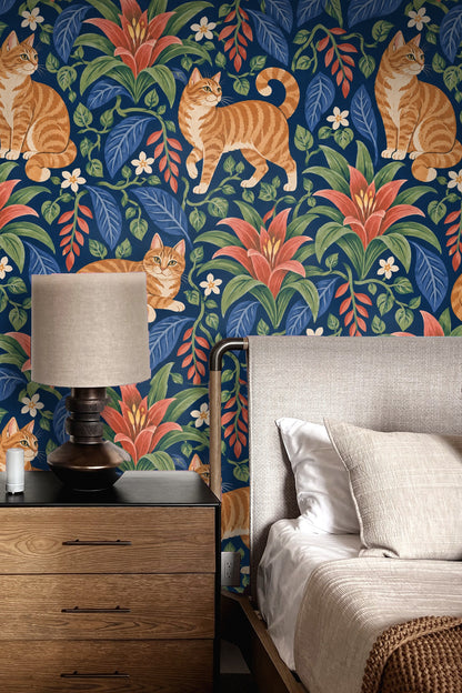 Wallpaper pattern with ginger tabby cats and red bromeliad flowers on indigo background