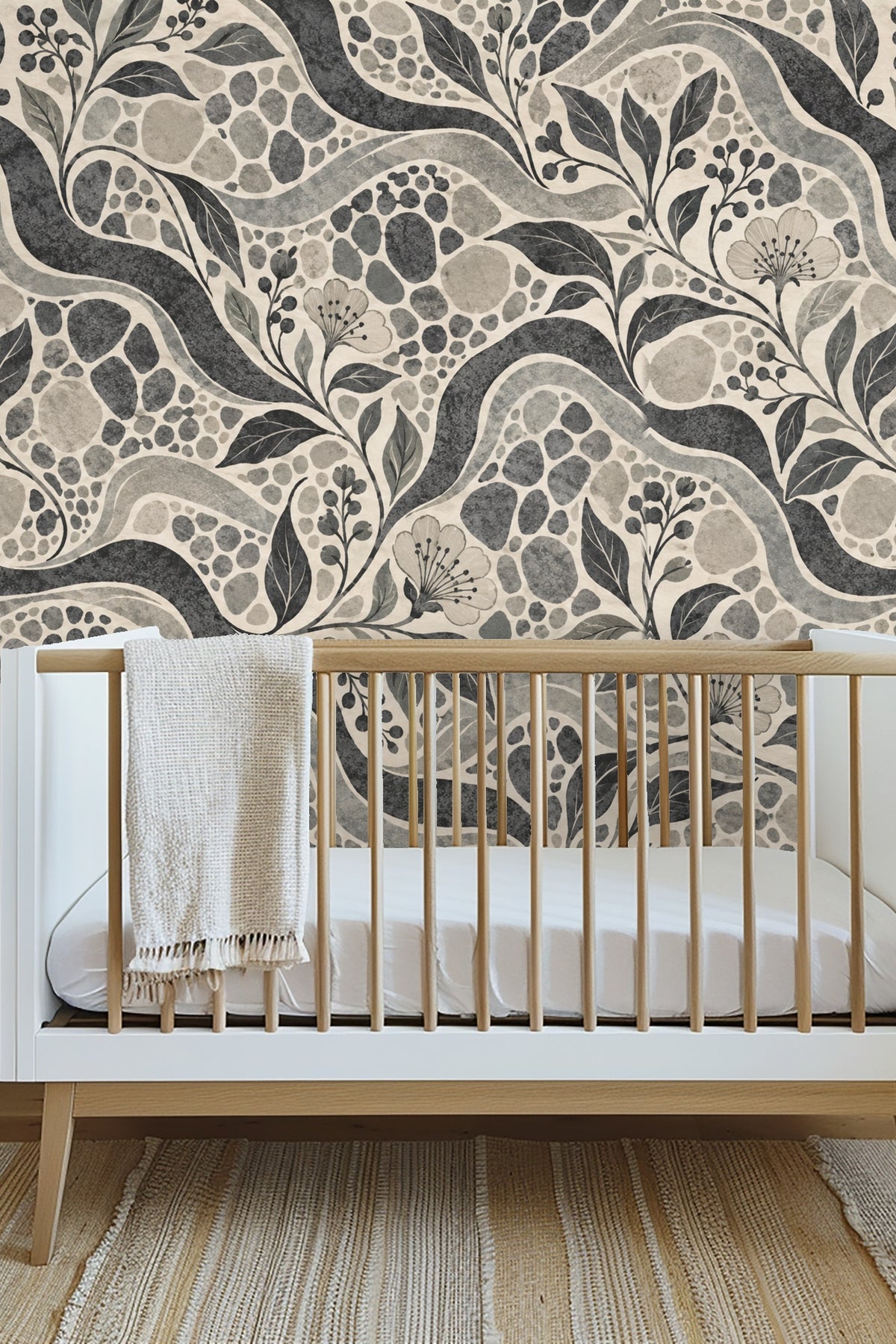 Close-up of floral and leaf motifs integrated into the abstract pebble field.