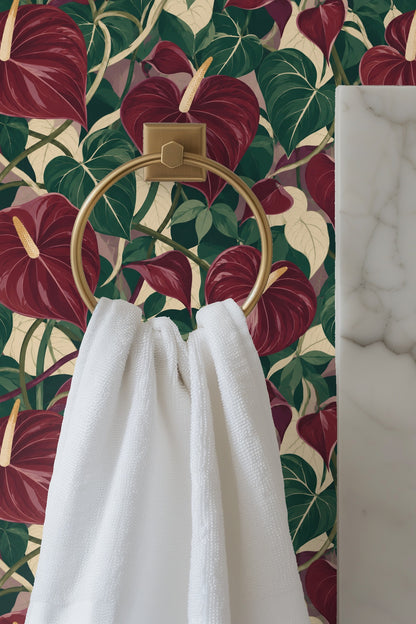 Detailed view of garnet anthurium flowers overlaying green and cream leaves in the wallpaper