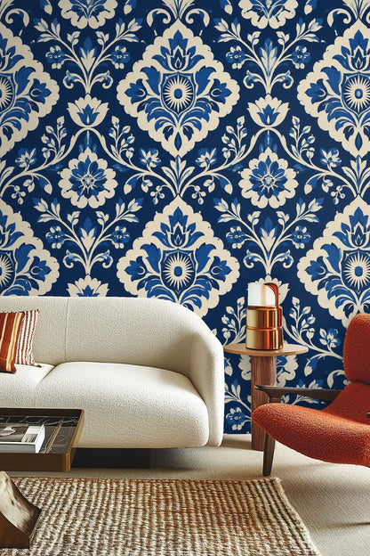Detail of cobalt blue damask wallpaper pattern with floral motifs and curling vines.
