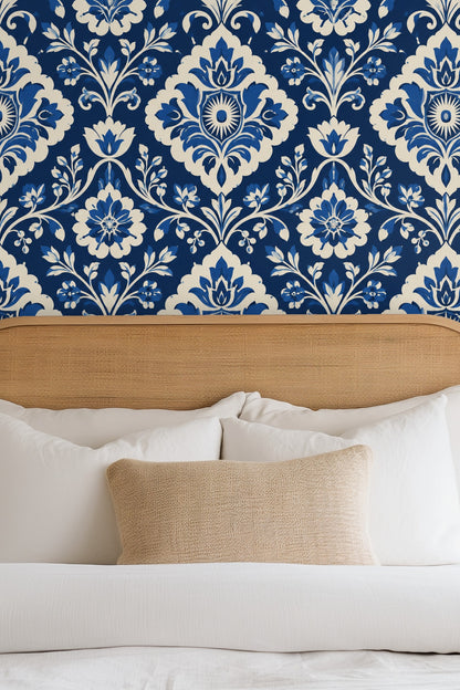 Section of wallpaper showing deep cobalt background and creamy floral contrasts.