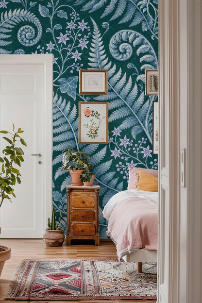 Detailed close-up of large fern frond spirals in soft blue tones on dark green wallpaper