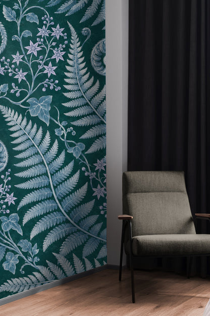 Section of wallpaper with delicate ivy leaves and curling fern scrolls in blue hues