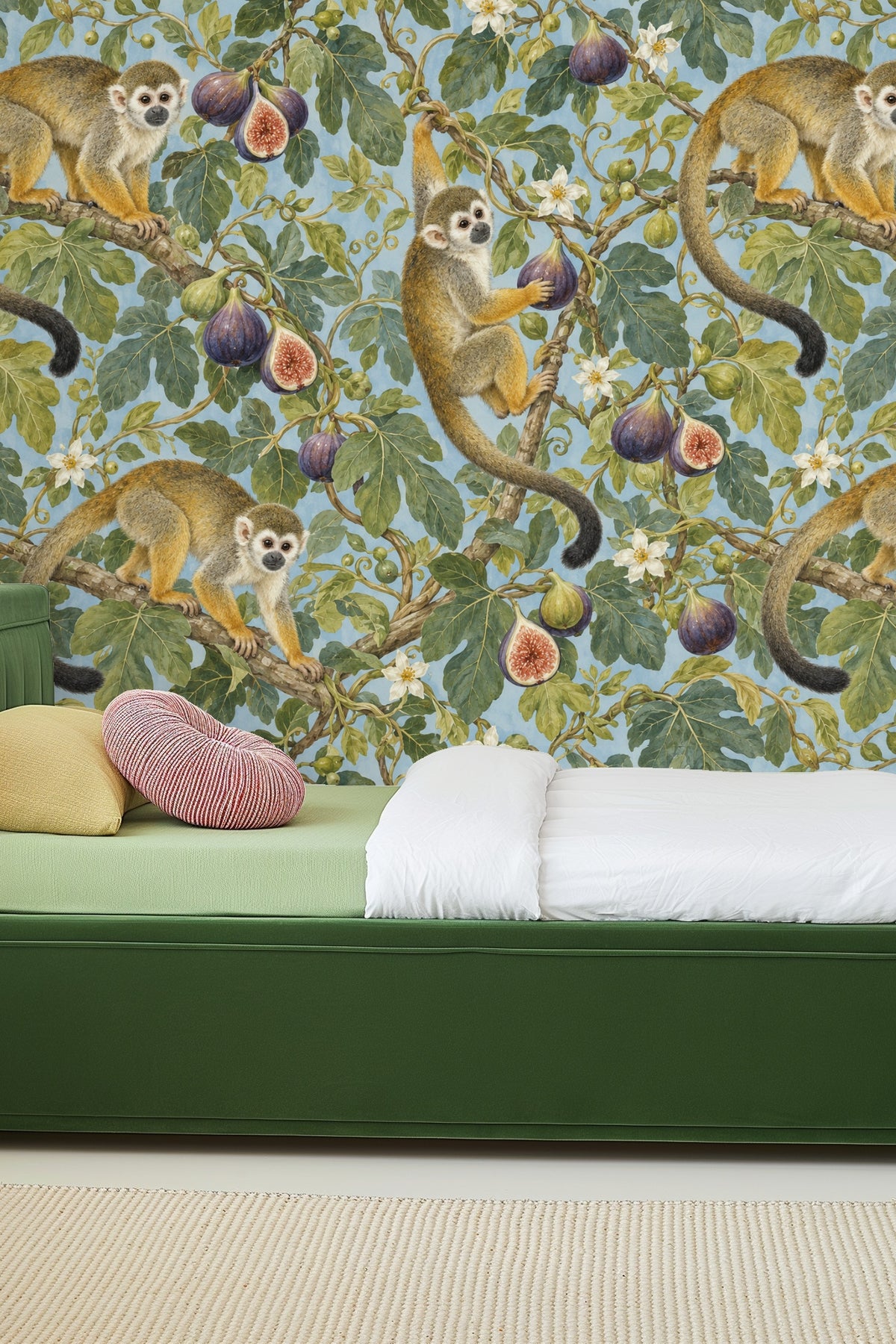 Room scene showing the wallpaper behind a light wood round side table and cream upholstered chair