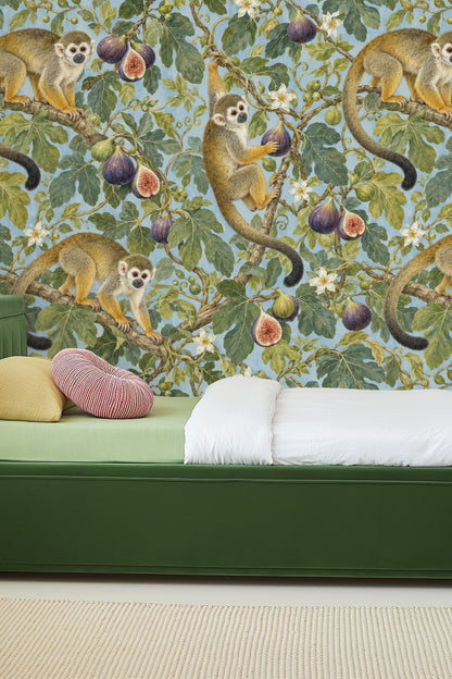 Room scene showing the wallpaper behind a light wood round side table and cream upholstered chair