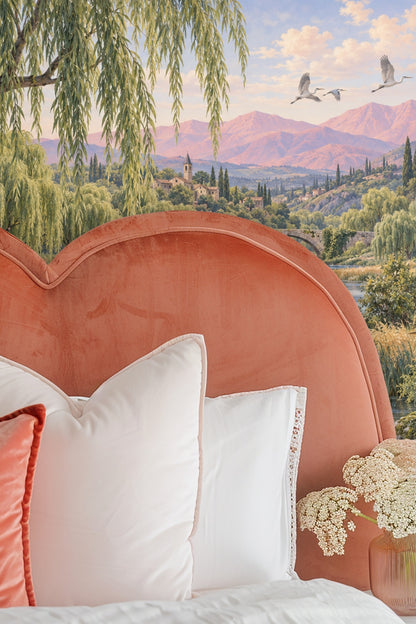 Living room with wallpaper mural of valley with copper willows and rustic bridge behind an orange sofa