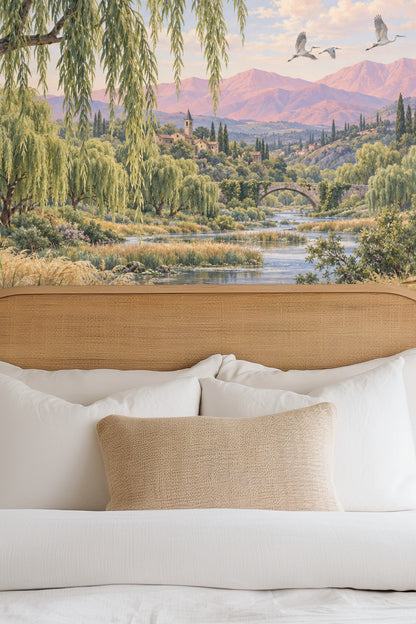 Swans gliding on the river surrounded by wildflowers and reeds