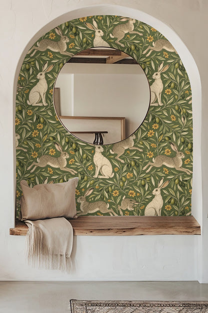 Close-up of wallpaper pattern with hares and olive branches on olive green background.