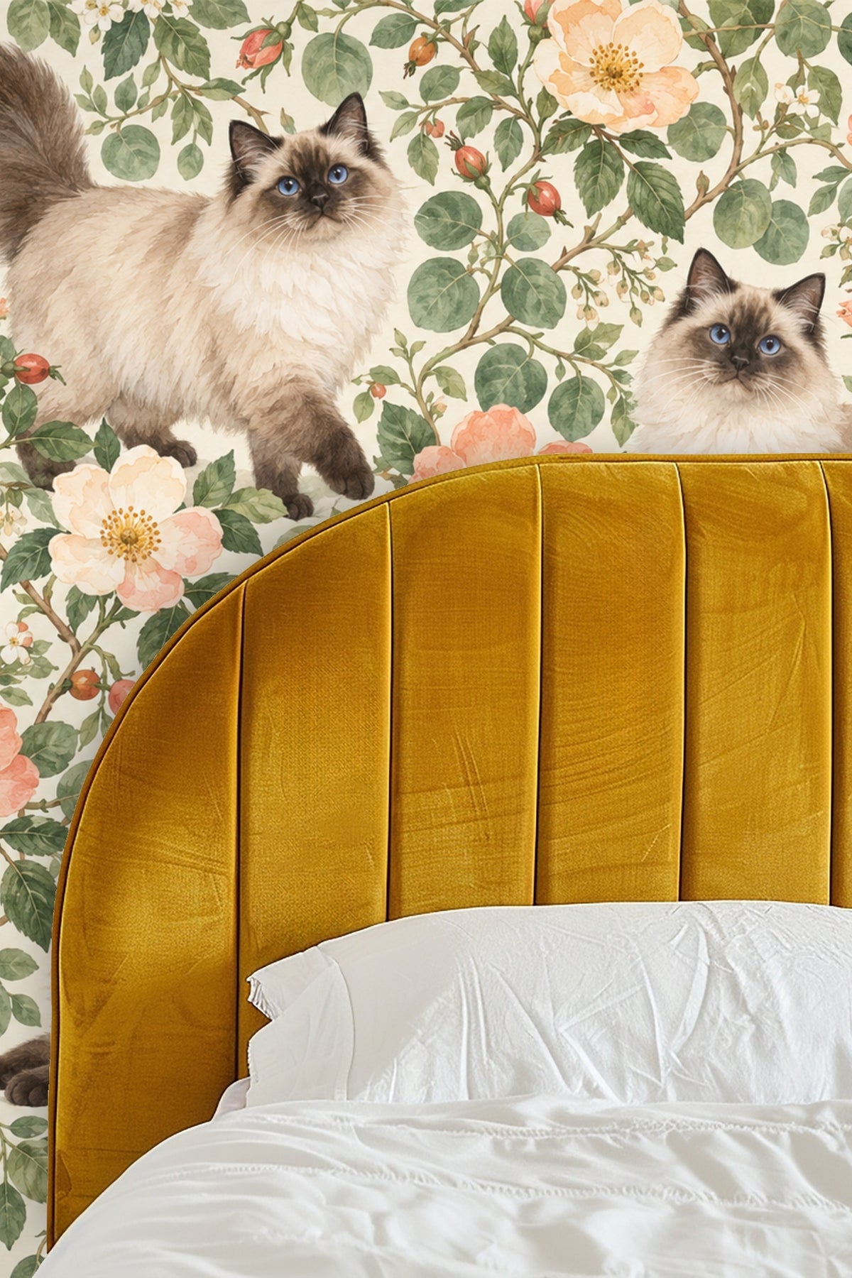 Side table and sofa in front of wallpaper emphasizes scale of cat and flower motifs