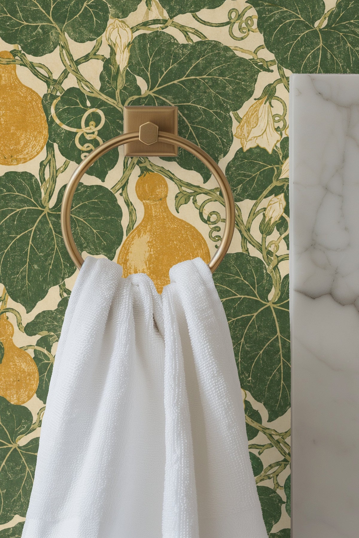 Detail of Moss Ribbon Gourds wallpaper behind a lit candle and vase with white flowers on a wooden surface.
