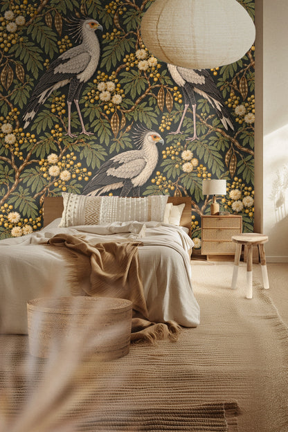 Living room with Bronze Secretary Birds wallpaper creating a bold feature wall behind an orange couch