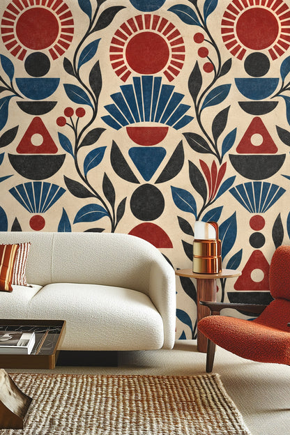 Pattern detail of Ruby Sunstack wallpaper showing stylized suns and foliage in red, blue, and black on beige
