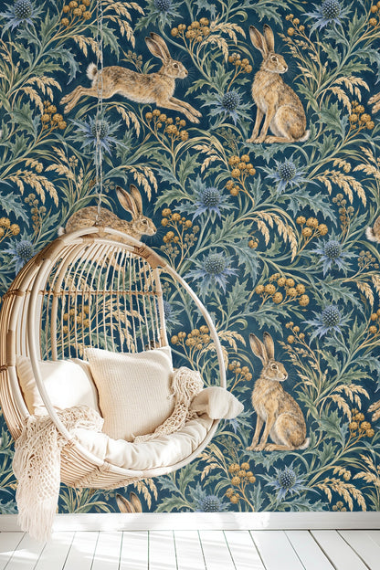 Bedroom featuring Sea Holly & Harewind wallpaper behind a bedside table and natural woven lamp