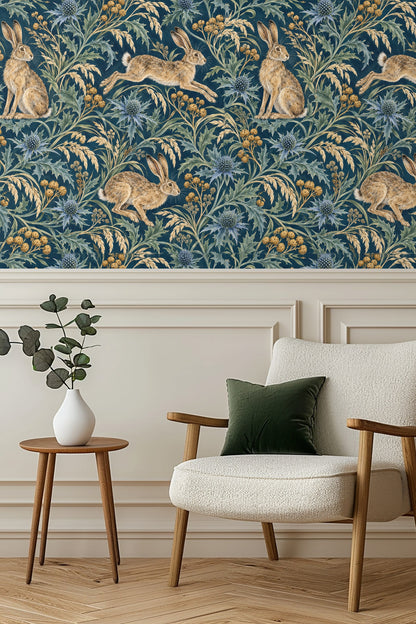 Close-up of detailed wallpaper artwork with hares, sea holly, and wild grasses on a deep blue background