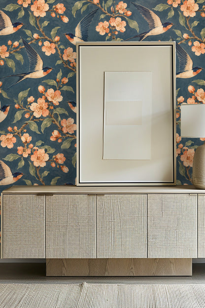 Laundry room with wooden counter, white washer/dryer, and floral swallow wallpaper