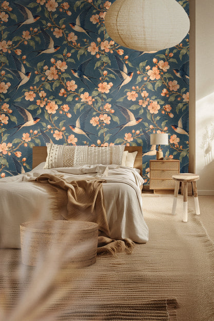 Close-up of apricot flower clusters and green leaves on blue wallpaper