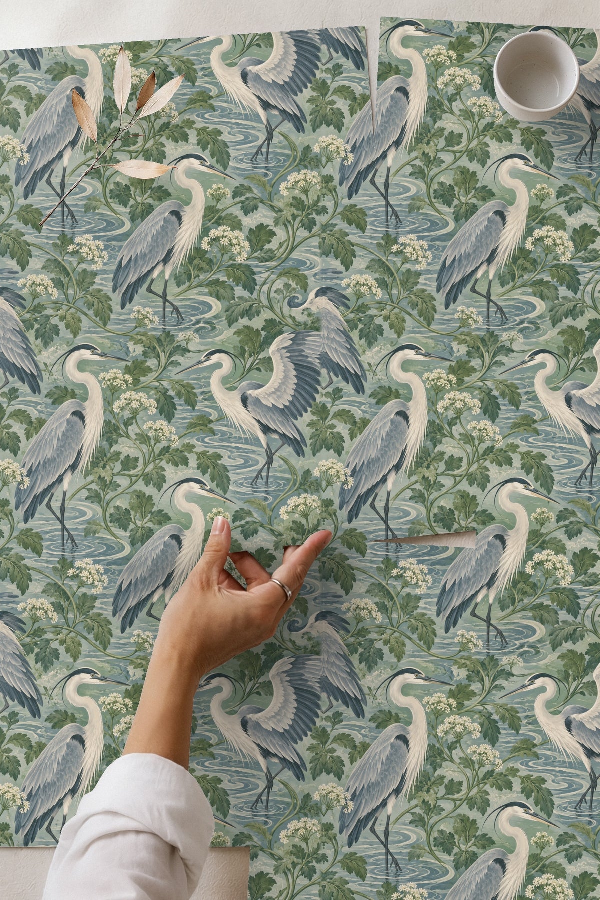 Close-up showing heron feathers and white flower clusters from Celadon Heron Loops wallpaper.