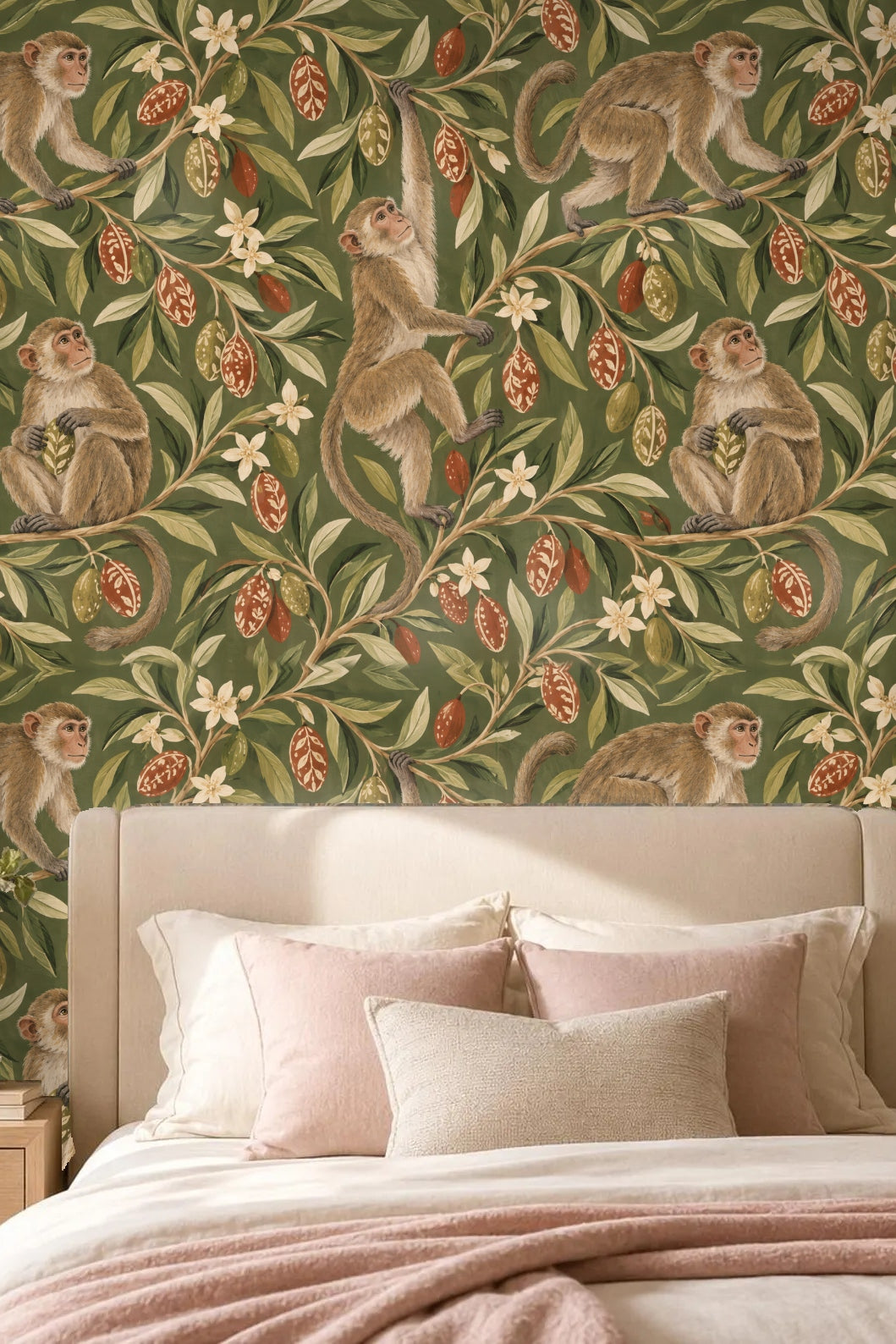 Living room with sofa and coffee table in front of wallpaper featuring playful macaques on olive foliage
