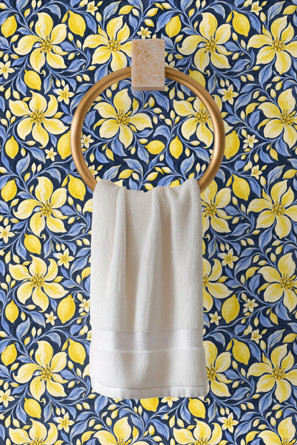 Close-up of wallpaper motifs showing large yellow floral petals and detailed lemon shapes.