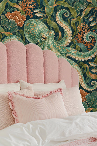 Bedroom corner highlighting wallpaper behind pillows with complementary coral and green palette.