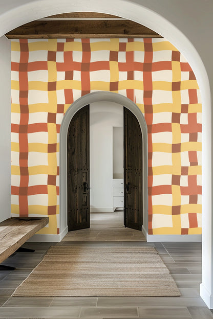 Bathroom wall with open wooden medicine cabinet and Tangier Plaid wallpaper pattern.
