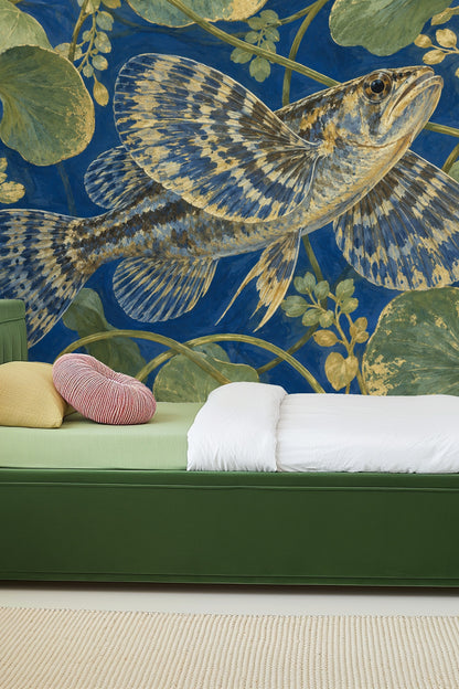 Living room featuring the bluefin fish and waterlily wallpaper behind a white curved sofa and warm-toned armchair