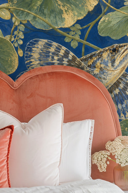 Bedroom with minimal decor accentuating the mural's deep blues