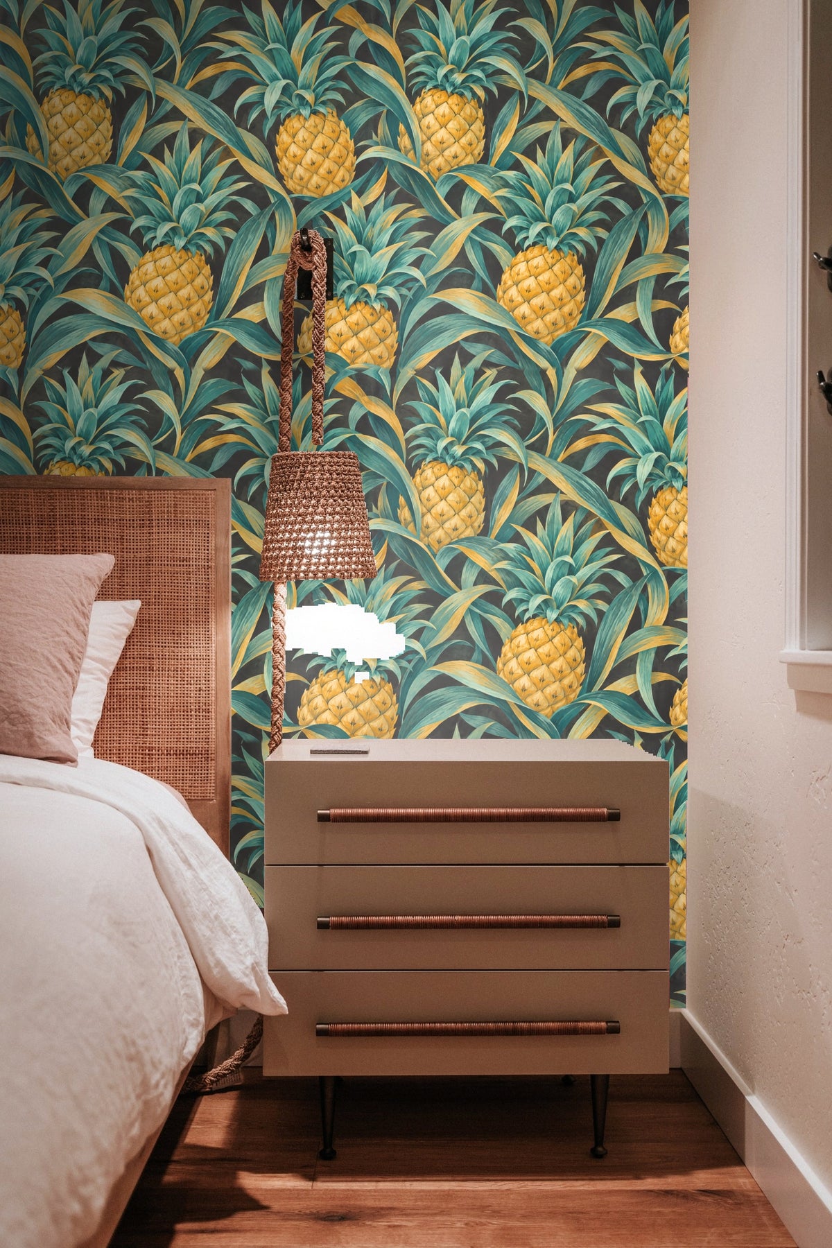 Pattern repeat showing overlapping pineapple crowns and leaves in organic arrangement.
