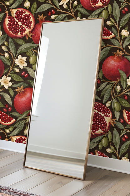 Section of wallpaper with clusters of pomegranate seeds and glossy dark leaves