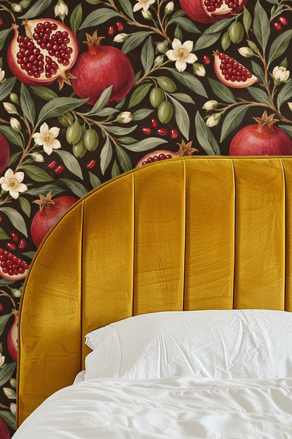 Interior detail with Pomegranate Night wallpaper, lit candle in glass container, and flower in a vase