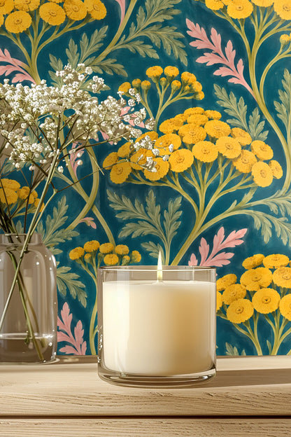 Bedroom scene with green velvet headboard set against wallpaper featuring bold yellow tansy flowers on a teal backdrop