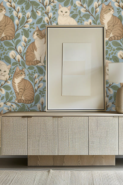 Digital artwork of tabby and white cats sitting among catkins on a soft blue background