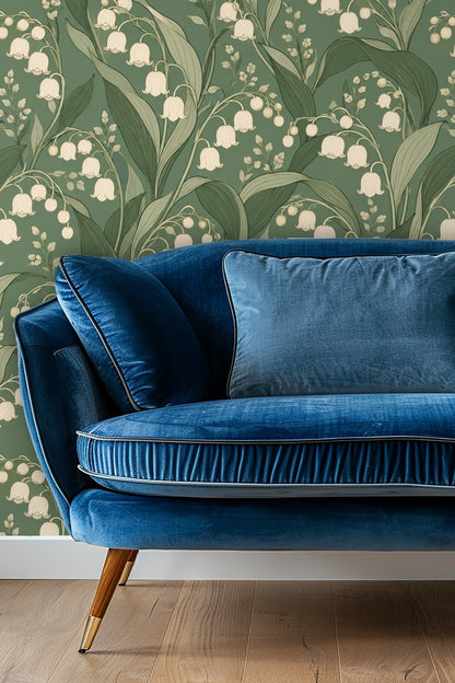 Bedroom setting with lush green velvet headboard against Verdant Lily Bells wallpaper