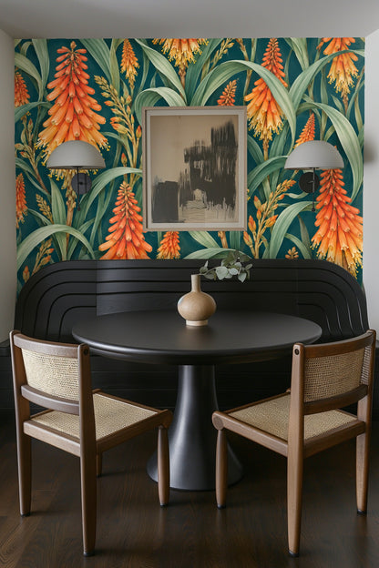 Green leaves curling around multiple orange flower spikes in the wallpaper design
